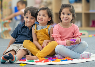 students smiling on the rug 