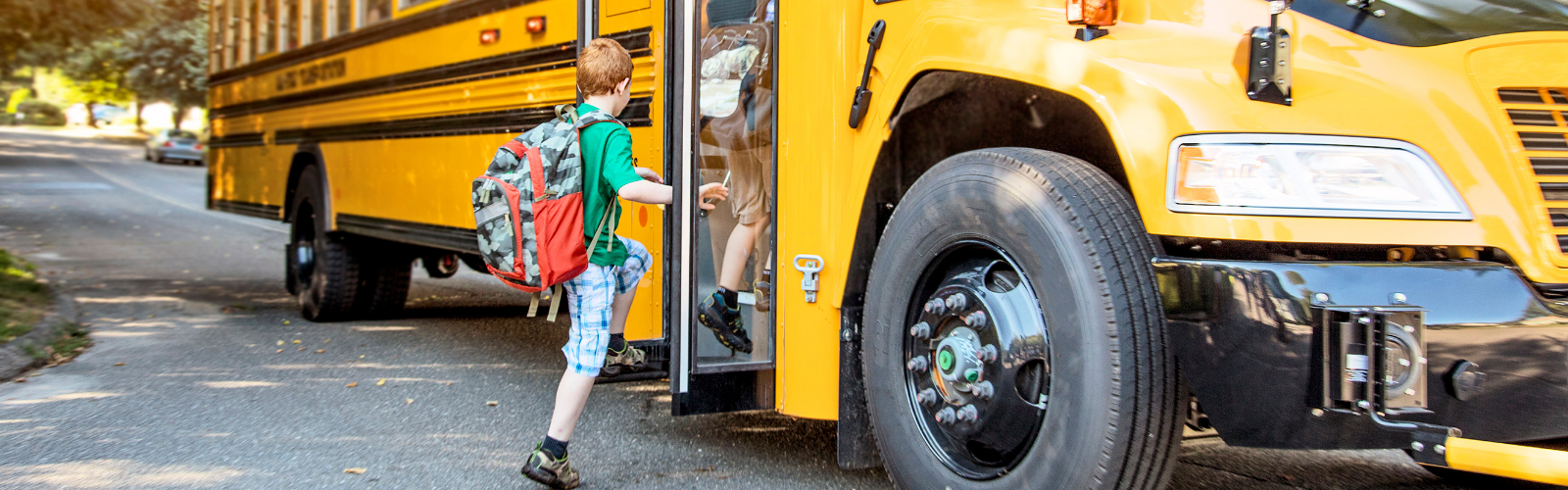 Child getting on school bus