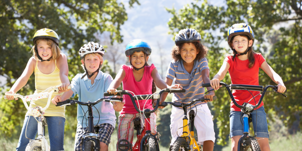 kids riding bikes with helmets on 