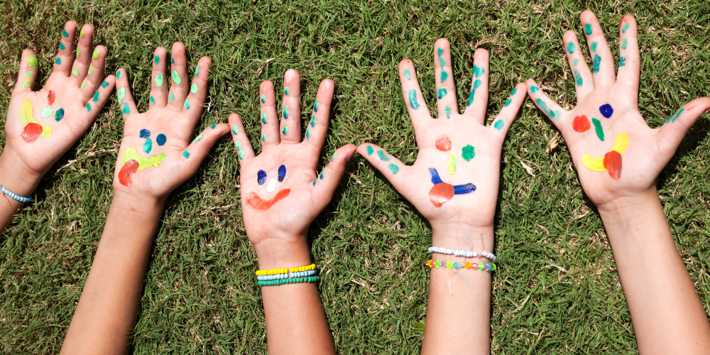 hands painted with smiley faces